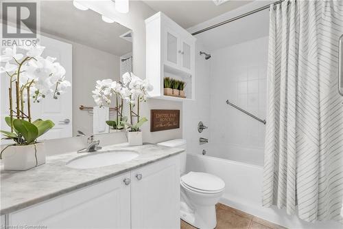 Full bathroom featuring toilet, vanity, tile patterned floors, and shower / bathtub combination with curtain - 2379 Central Park Drive Unit# 206, Oakville, ON - Indoor Photo Showing Bathroom