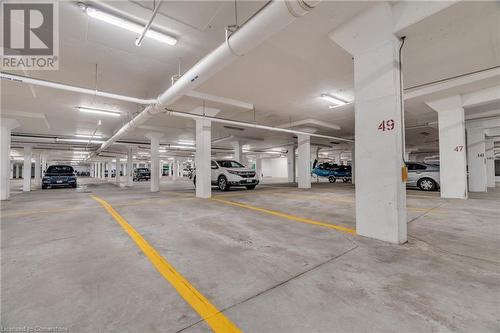 View of garage - 2379 Central Park Drive Unit# 206, Oakville, ON - Indoor Photo Showing Garage