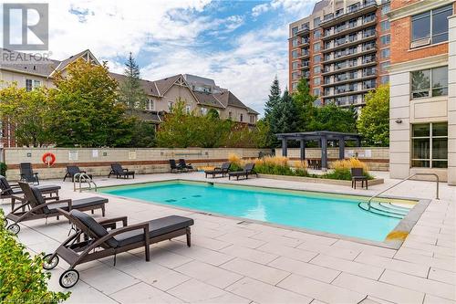 View of pool with a pergola and a patio area - 2379 Central Park Drive Unit# 206, Oakville, ON - Outdoor With In Ground Pool