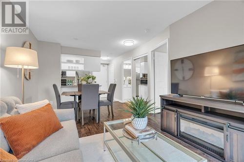 Living room with wood-type flooring - 2379 Central Park Drive Unit# 206, Oakville, ON - Indoor