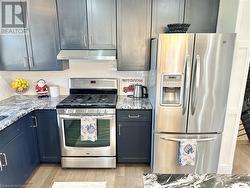 Kitchen - featuring the stainless Refrigerator and Gas Stove - 