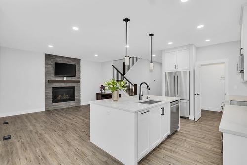 1938 Hemmerling Court, Kelowna, BC - Indoor Photo Showing Kitchen With Fireplace With Upgraded Kitchen