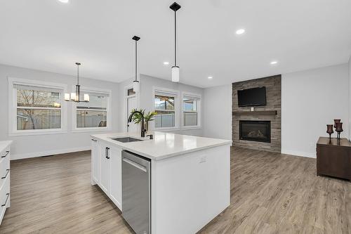 1938 Hemmerling Court, Kelowna, BC - Indoor Photo Showing Kitchen With Fireplace