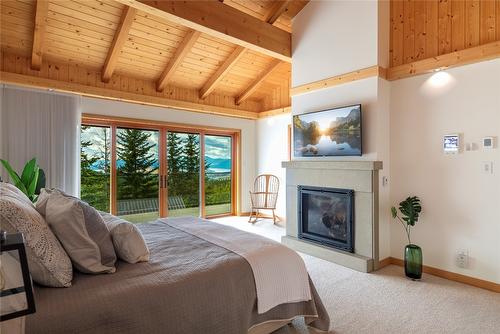 8100, 8104 Silver Star Road, Vernon, BC - Indoor Photo Showing Bedroom With Fireplace