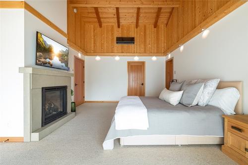 8100, 8104 Silver Star Road, Vernon, BC - Indoor Photo Showing Bedroom With Fireplace