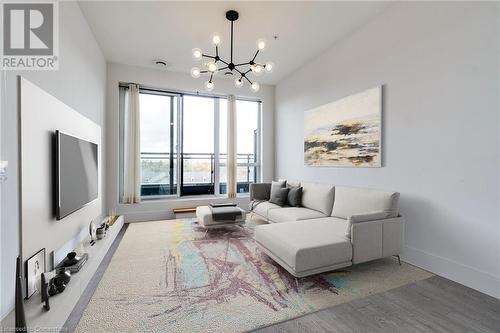 Living room with wood-type flooring and an inviting chandelier - 15 Prince Albert Boulevard Unit# 610, Kitchener, ON - Indoor Photo Showing Other Room