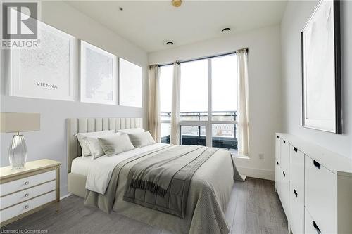 Bedroom with multiple windows and dark hardwood / wood-style floors - 15 Prince Albert Boulevard Unit# 610, Kitchener, ON - Indoor Photo Showing Bedroom