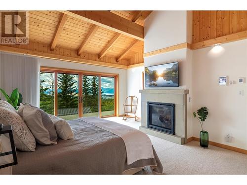 8100, 8104 Silver Star Road, Vernon, BC - Indoor Photo Showing Bedroom With Fireplace