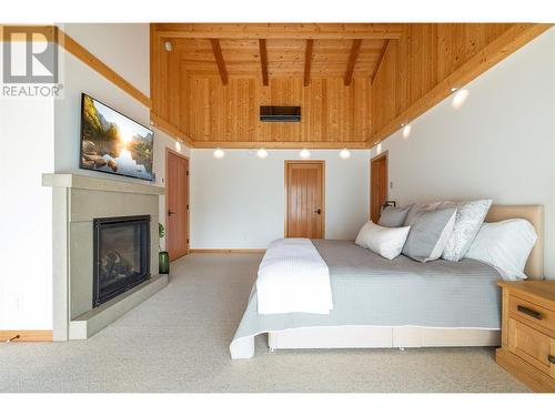 8100, 8104 Silver Star Road, Vernon, BC - Indoor Photo Showing Bedroom With Fireplace