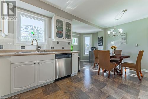 Kitchen featuring dishwasher, white cabinetry, sink, and backsplash - 2080 Sixth Line, Oakville, ON - Indoor