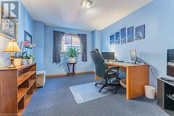 Carpeted office space featuring a textured ceiling - 