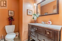 Bathroom featuring toilet, vanity, and tile patterned floors - 