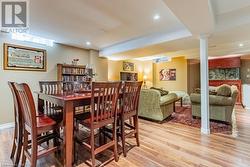 Dining area featuring light hardwood / wood-style floors and decorative columns - 