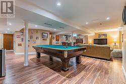 Playroom with wood-type flooring and billiards - 