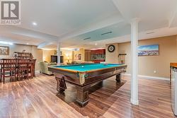 Recreation room with light wood-type flooring and pool table - 