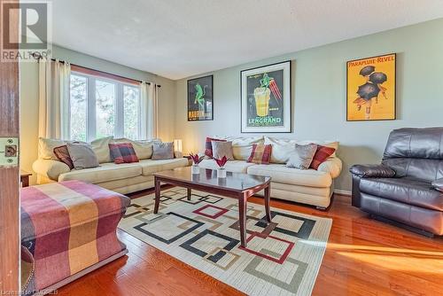 Living room with hardwood / wood-style floors and a textured ceiling - 2080 Sixth Line, Oakville, ON - Indoor Photo Showing Living Room