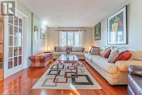 Living room with wood-type flooring and a textured ceiling - 2080 Sixth Line, Oakville, ON - Indoor Photo Showing Living Room