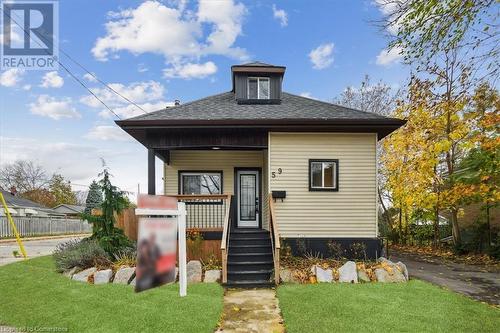 Bungalow-style house with a front lawn and covered porch - 59 Stanley Street, Brantford, ON - Outdoor