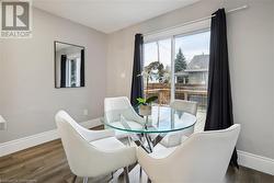 Dining area with dark wood-type flooring - 