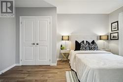 Bedroom with hardwood / wood-style floors and a closet - 