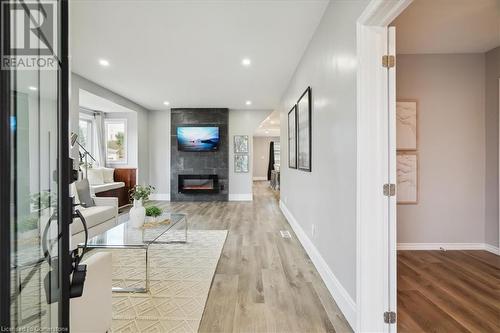 Corridor featuring light hardwood / wood-style flooring - 59 Stanley Street, Brantford, ON - Indoor Photo Showing Living Room With Fireplace