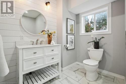 Bathroom with wood walls, vanity, and toilet - 59 Stanley Street, Brantford, ON - Indoor Photo Showing Bathroom