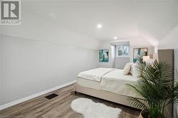 Bedroom featuring hardwood / wood-style flooring and vaulted ceiling - 