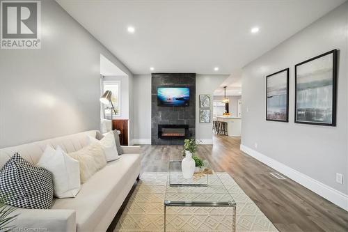 Living room featuring a tiled fireplace and hardwood / wood-style floors - 59 Stanley Street, Brantford, ON - Indoor Photo Showing Living Room With Fireplace