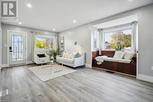 Sitting room with a healthy amount of sunlight and light hardwood / wood-style flooring - 59 Stanley Street, Brantford, ON - Indoor Photo Showing Living Room