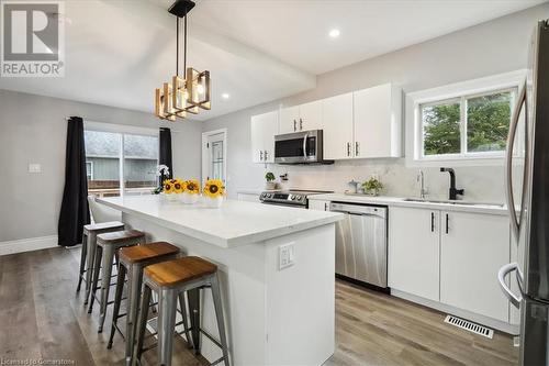 Kitchen featuring plenty of natural light, a center island, appliances with stainless steel finishes, and white cabinets - 59 Stanley Street, Brantford, ON - Indoor Photo Showing Kitchen With Stainless Steel Kitchen With Upgraded Kitchen