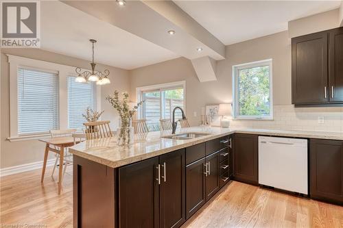 Kitchen with white dishwasher, light hardwood / wood-style floors, plenty of natural light, and sink - 262 Homewood Avenue, Hamilton, ON - Indoor Photo Showing Kitchen With Double Sink