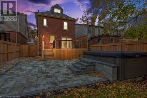 Back house at dusk with a hot tub, a patio, and a deck - 262 Homewood Avenue, Hamilton, ON - Outdoor With Deck Patio Veranda