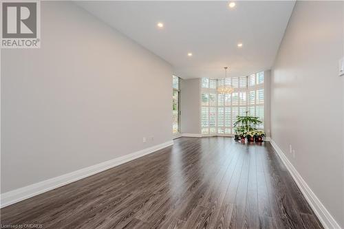 Empty room with dark wood-type flooring - 2511 Lakeshore Road W Unit# 108, Oakville, ON - Indoor Photo Showing Other Room