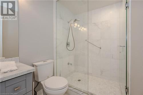 Bathroom with vanity, toilet, and a shower with shower door - 2511 Lakeshore Road W Unit# 108, Oakville, ON - Indoor Photo Showing Bathroom