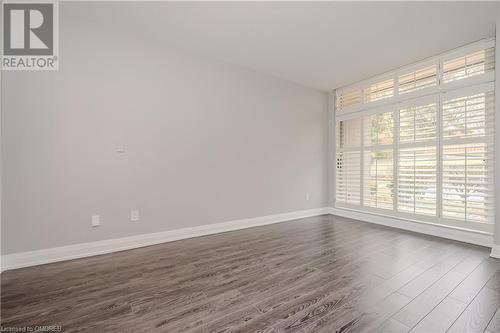 Empty room with dark hardwood / wood-style flooring - 2511 Lakeshore Road W Unit# 108, Oakville, ON - Indoor Photo Showing Other Room