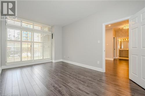 Unfurnished room with dark hardwood / wood-style floors - 2511 Lakeshore Road W Unit# 108, Oakville, ON - Indoor Photo Showing Other Room