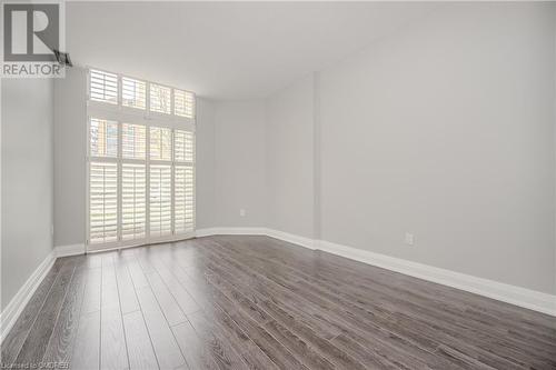 Unfurnished room with dark hardwood / wood-style floors - 2511 Lakeshore Road W Unit# 108, Oakville, ON - Indoor Photo Showing Other Room