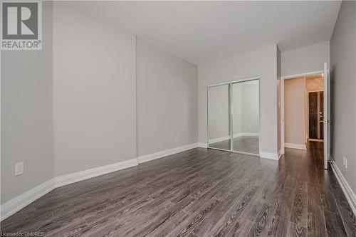 Unfurnished bedroom featuring dark wood-type flooring and a closet - 2511 Lakeshore Road W Unit# 108, Oakville, ON - Indoor Photo Showing Other Room