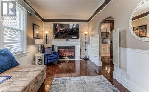 Living room featuring dark hardwood / wood-style floors and ornamental molding - 52 Adam Street, Cambridge, ON - Indoor With Fireplace