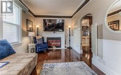 Living room featuring dark hardwood / wood-style floors and ornamental molding - 