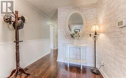 Hall featuring dark hardwood / wood-style floors and crown molding - 