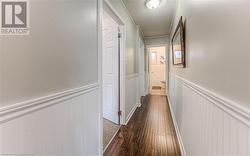 Hallway featuring a textured ceiling and dark hardwood / wood-style flooring - 