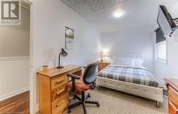 Bedroom featuring wood walls and hardwood / wood-style flooring - 