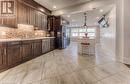 Kitchen with stainless steel appliances, sink, tasteful backsplash, dark brown cabinets, and decorative light fixtures - 52 Adam Street, Cambridge, ON  - Indoor 