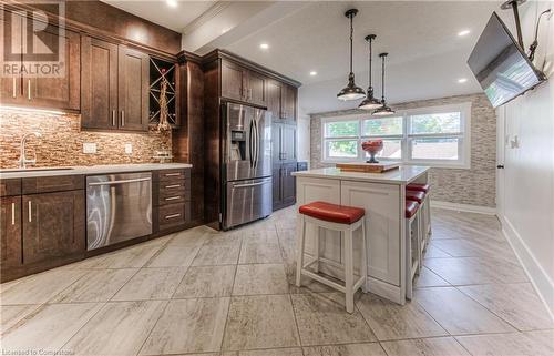 Kitchen featuring stainless steel appliances, sink, a kitchen breakfast bar, a kitchen island, and pendant lighting - 52 Adam Street, Cambridge, ON - Indoor Photo Showing Kitchen With Upgraded Kitchen