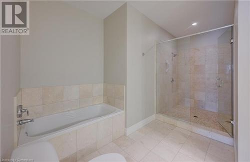 Bathroom featuring toilet, plus walk in shower, and tile patterned floors - 223 Erb Street W Unit# 903, Waterloo, ON - Indoor Photo Showing Bathroom