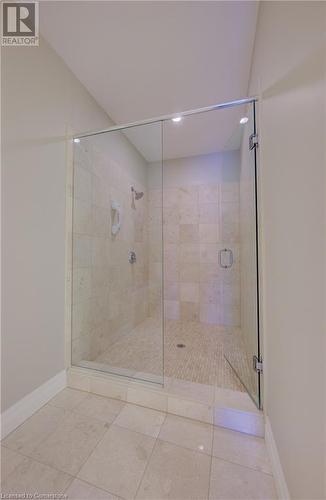 Bathroom featuring tile patterned floors and a shower with door - 223 Erb Street W Unit# 903, Waterloo, ON - Indoor Photo Showing Bathroom