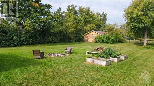 Gorgeous backyard with outbuildings, gardens, pastures and fire pit. - 3161 Mackey Road, Manotick - Kars - Rideau Twp And Area (8008 - Rideau Twp S Of Reg Rd 6 W Of Mccordick Rd.), ON - Outdoor With Backyard