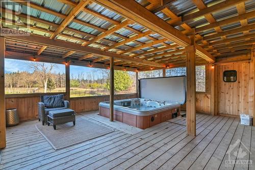 Huge screened-in porch with hot tub & sauna overlooking the backyard. - 3161 Mackey Road, Manotick - Kars - Rideau Twp And Area (8008 - Rideau Twp S Of Reg Rd 6 W Of Mccordick Rd.), ON - Outdoor With Deck Patio Veranda With Exterior