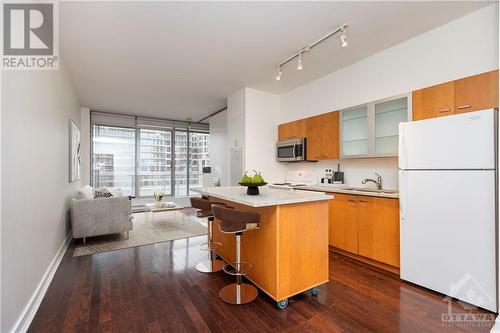 With 9-foot ceilings and panoramic views, this condo brings together comfort, style, and the best of downtown living. - 383 Cumberland Street Unit#710, Ottawa, ON - Indoor Photo Showing Kitchen